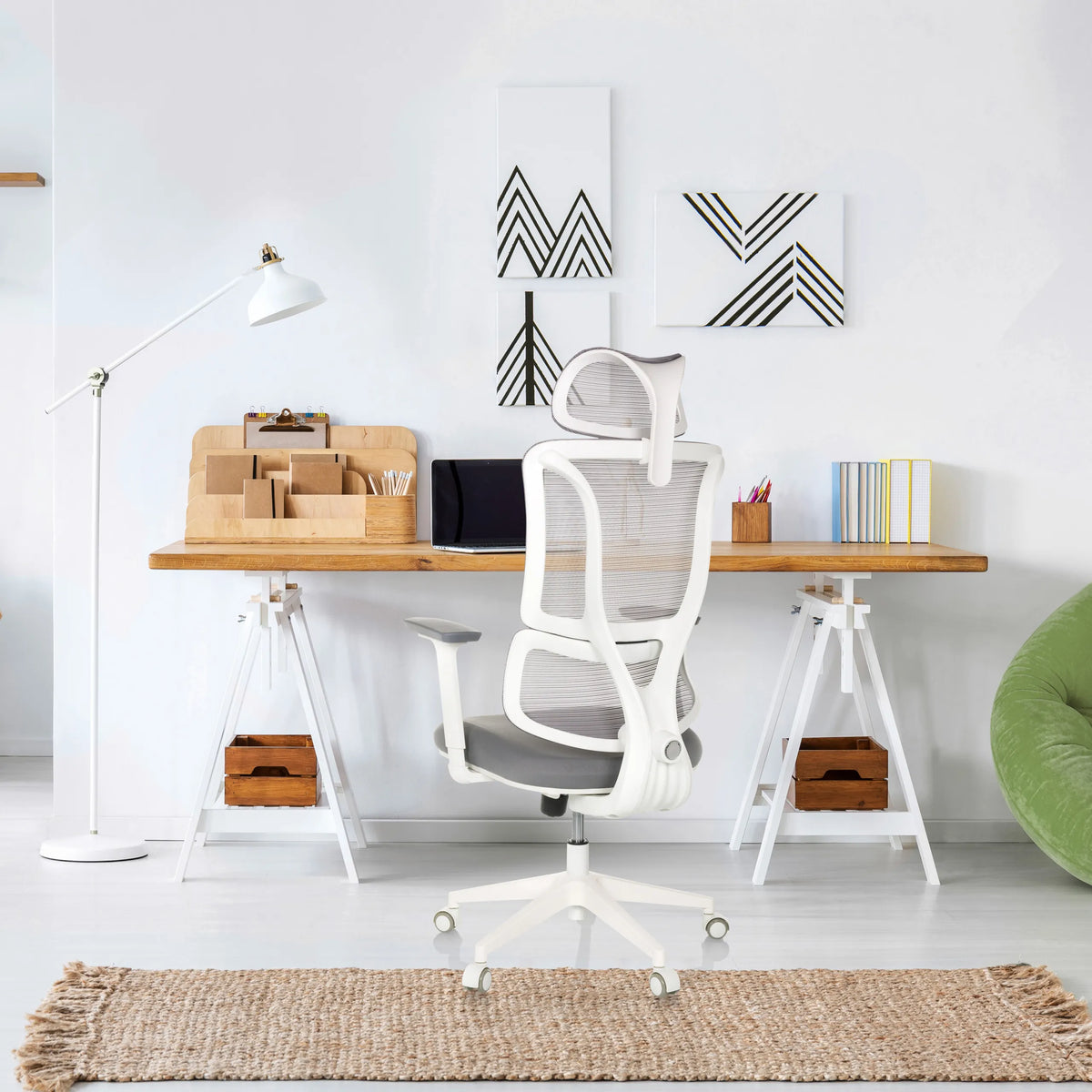 Silla de oficina profesional ERGOMY W en gris con estructura blanca y respaldo de malla en un escritorio de MyBuero