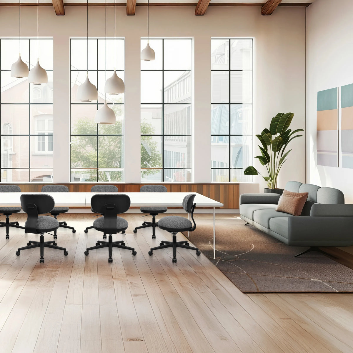 Silla Home Office SITMOTION B gris con ruedas y reposabrazos en una oficina luminosa de hjh OFFICE