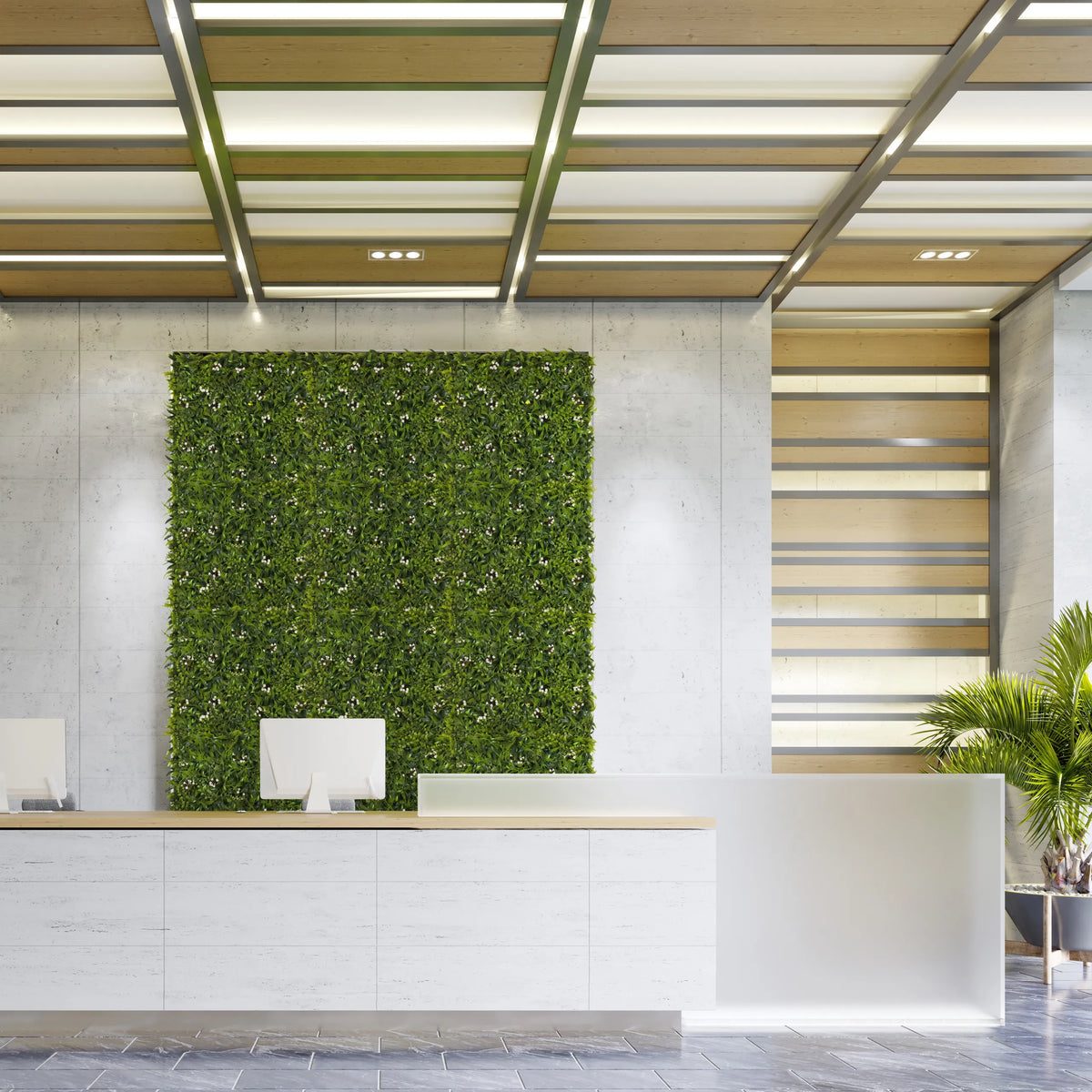 Estera vegetal verde MORE GREEN I como vegetación vertical en una pared de hormigón clara en una zona de recepción de hjh OFFICE