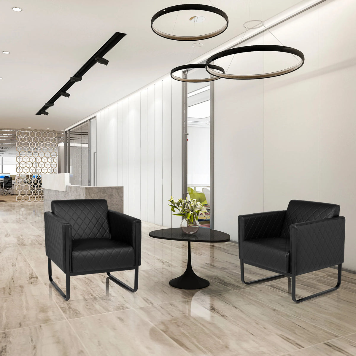 Dos sillones tapizados ARUBA BLACK negros con capitoné y estructura de patín junto a una mesa auxiliar redonda de hjh OFFICE