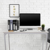 Escritorio blanco WORKSPACE I de 100 × 50 cm frente a una pared de ladrillo blanco de hjh OFFICE