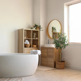 Planta artificial verde OLIVE II en una cesta tejida junto a un lavabo de baño de hjh OFFICE