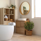 Planta artificial verde Olive S en una cesta tejida junto a un mueble de baño de hjh OFFICE