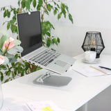 Soporte para portátil LAPTOP STAND plateado con soporte ajustable sobre un escritorio blanco de hjh OFFICE
