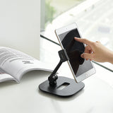Soporte para teléfono móvil y tableta FLEXMOBI IV en color negro con una tableta insertada sobre un fondo blanco de hjh OFFICE