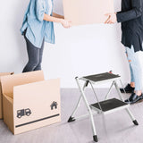 Escalera plegable blanca SOLID W1 con dos peldaños negros junto a una caja de mudanza de hjh OFFICE