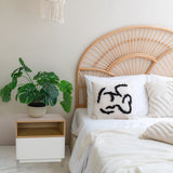 Mesa auxiliar blanca MELMO con estante abierto efecto roble junto a una cama de hjh LIVING