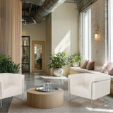 Dos sillones de diseño Curacao Cord blancos con estructura metálica y una mesa de centro redonda de hjh LIVING