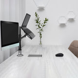 Soporte de monitor negro VM-MH2 con un monitor y un portátil sobre un escritorio blanco de hjh OFFICE